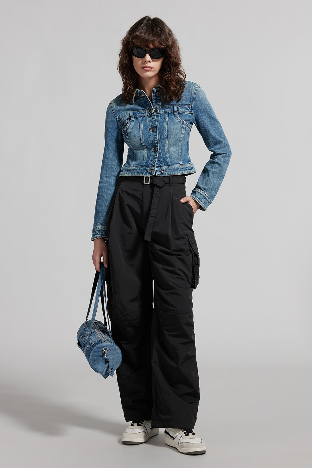 Woman wearing black cargo pants with a denim jacket